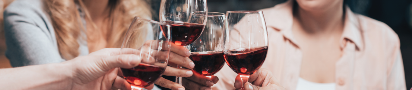 Freunde stoßen mit Rotwein an, Weinshop